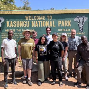 CWRU engineering students in front of sign for Kasungu National Park