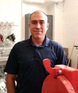Photo of Diego Franco Ocampo standing in a room surrounded by engineering eqipment
