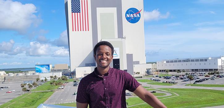 student in front of the NASA building