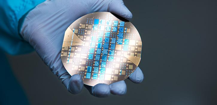 hand holding round microchip