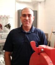 Photo of Diego Franco Ocampo standing in a room surrounded by engineering eqipment