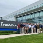Andrew Ausse with group next to Swagelok sign