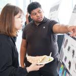 Student pointing at poster presentation