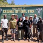 CWRU engineering students in front of sign for Kasungu National Park