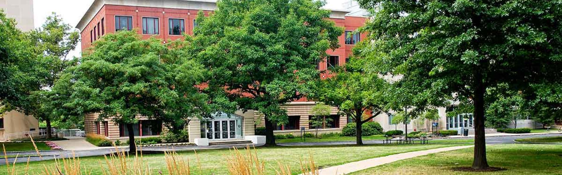 Exterior shot of academic building surrounded by trees