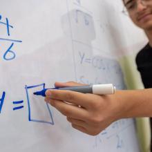 hand writing on a whiteboard