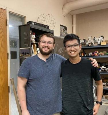 Two researchers standing together in a lab