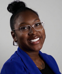 Picture is Keli Bryant, smiling wearing a blue jacket. 