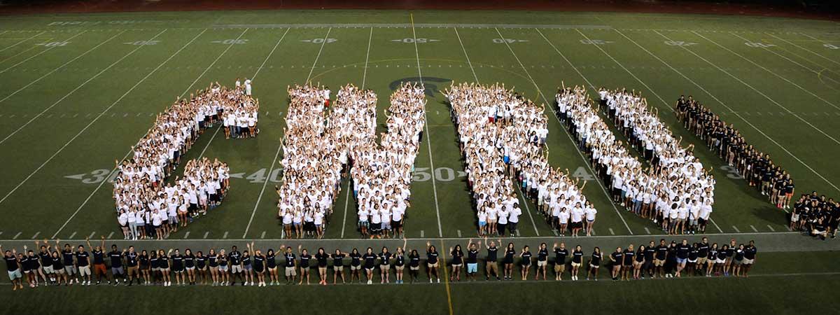Case Western Reserve University students lining up to spell "CWRU" on the football field