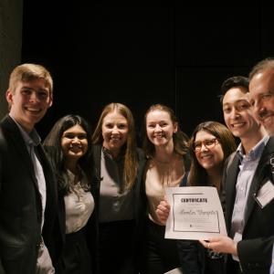 A group of smiling people holding a winning certificate that reads Lumilin Therapeutics