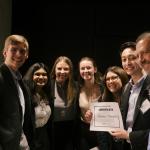 A group of smiling people holding a winning certificate that reads Lumilin Therapeutics