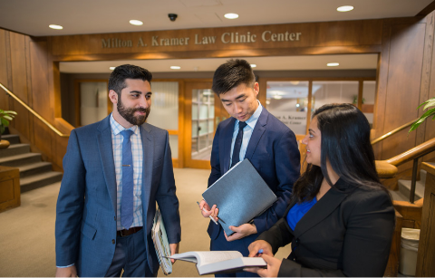 Law students talking in front of the Clinic entrance