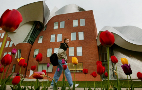 Exterior of the Weatherhead building with a student walking in front