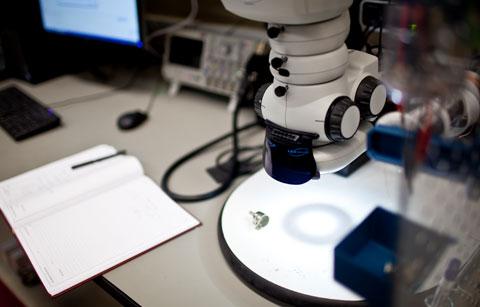 image of a desk with notebook and lab equipment