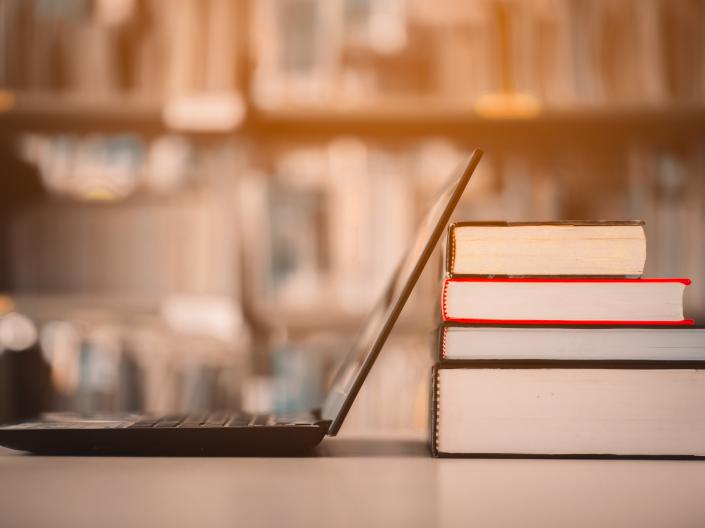 Laptop and a stack of books
