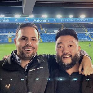 Mark Gorski and Stan Mimoto smiling in front of stadium