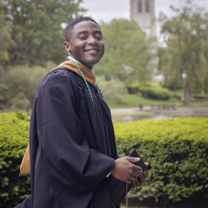 portrait of Nyasha in graduation robe - smiling
