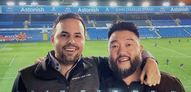Mark Gorski and Stan Mimoto smiling in front of stadium