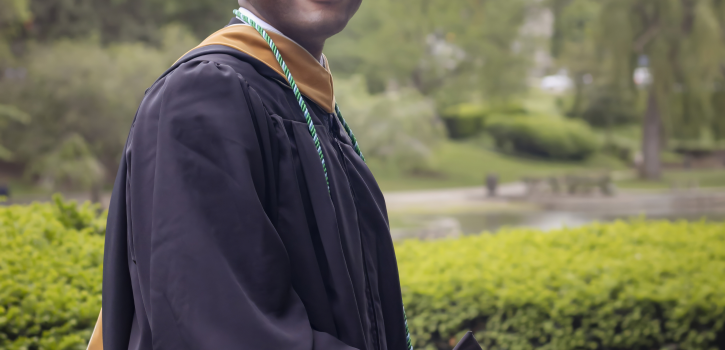 portrait of Nyasha in graduation robe - smiling