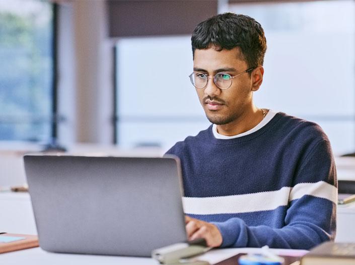 A person sits at a computer typing