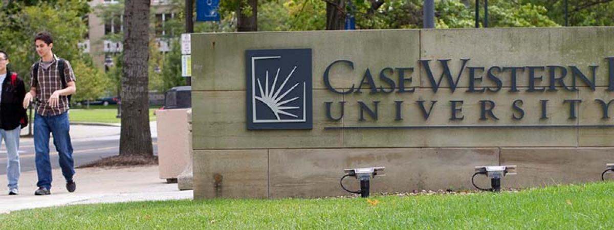 Case Western Reserve University Est. 1826 concrete sign students walking past