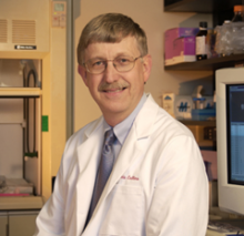 Headshot of Francis S. Collins in a medical lab