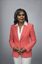 Photo by Celeste Sloman. Anita Hill standing in a pink blazer and white pants