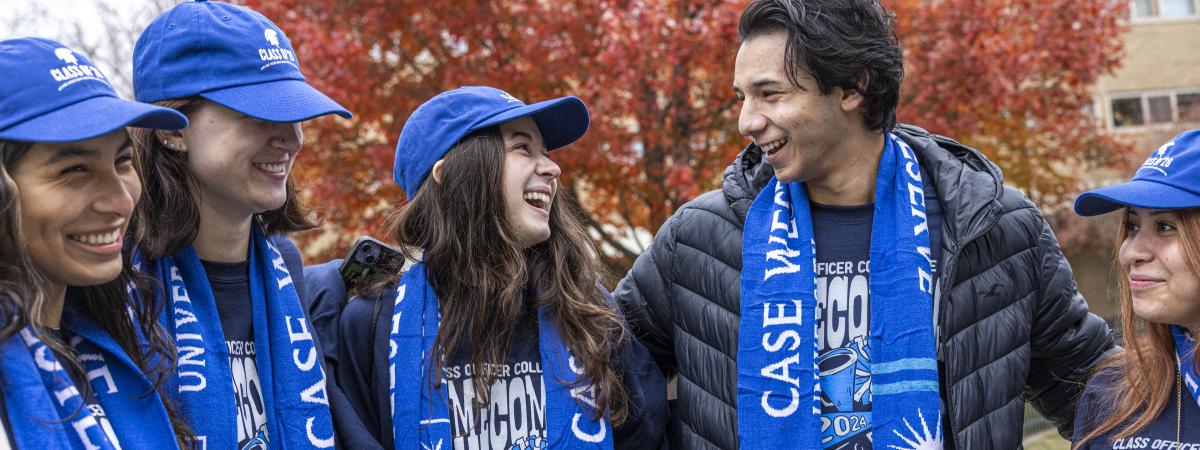 Students wearing CWRU gear speak to each other outside