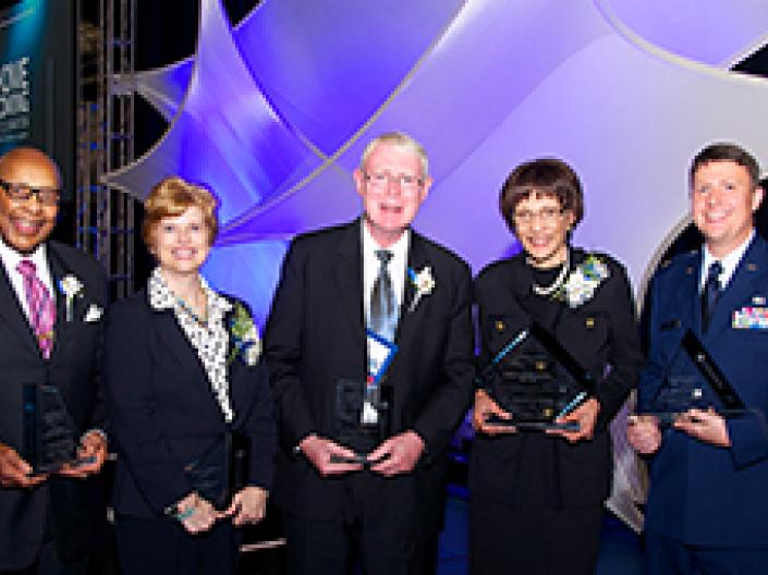 A group of Case Western Reserve University alumni award recipients holding their awards