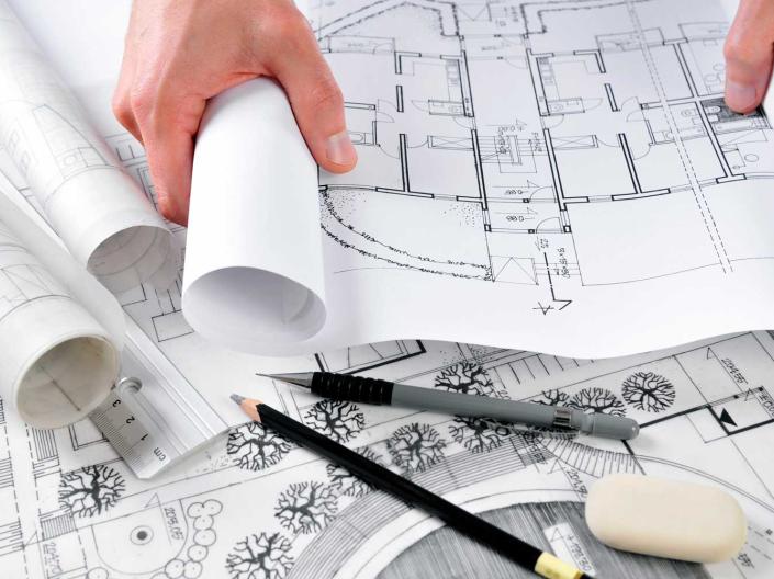 Person reviewing architectural designs.