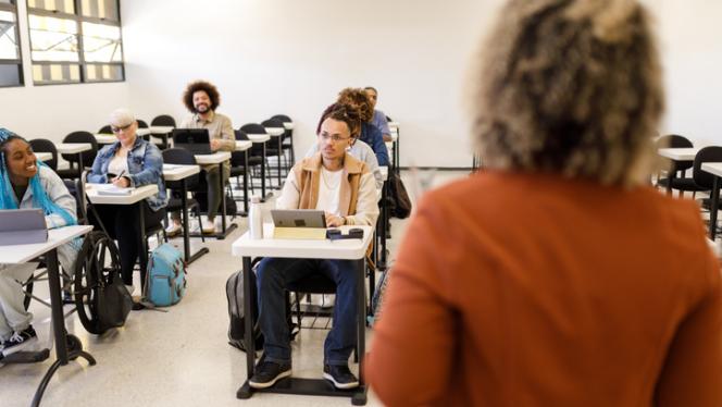 A faculty member standing in front of students in a classroom.