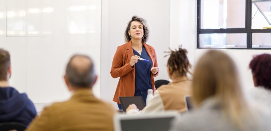 Professor teaching in a full classroom.