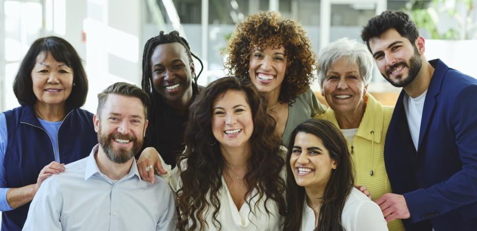A group of people standing together smiling.