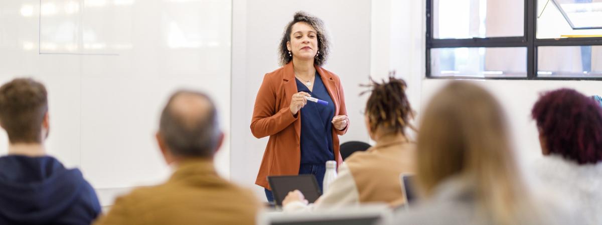 Professor teaching in a full classroom.