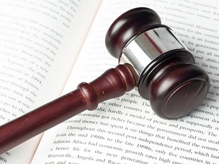 Judges gavel placed on top of a handbook