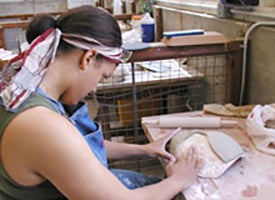 Student working with ceramics at CWRU Ceramics Studio at University Farm