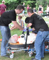 Two nurses working with victim on a stretcher during CWRU Flight Nursing Summer Camp