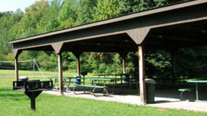 View of Picnic area at CWRU Farm, with enclosure, picnic benches and a barbecue 
