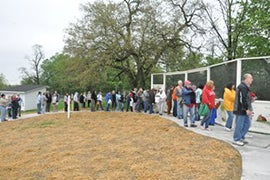 Line of people standing in line in front of A.I. Root Apiary and Honey House