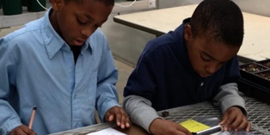 Two young students studying nature at CWRU Farm