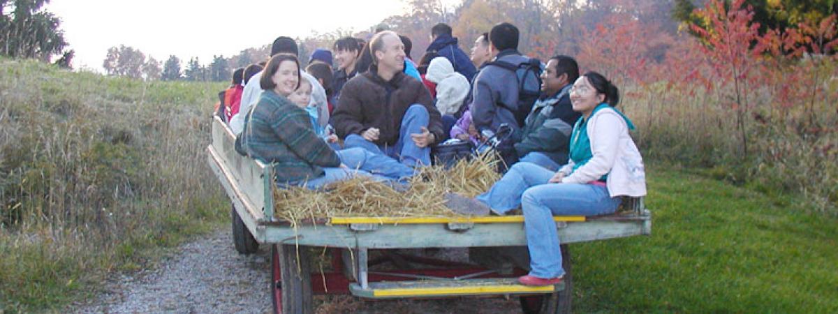 People of all ages on a hayride through the countryside