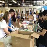 group of students volunteering and packing boxes at medwish