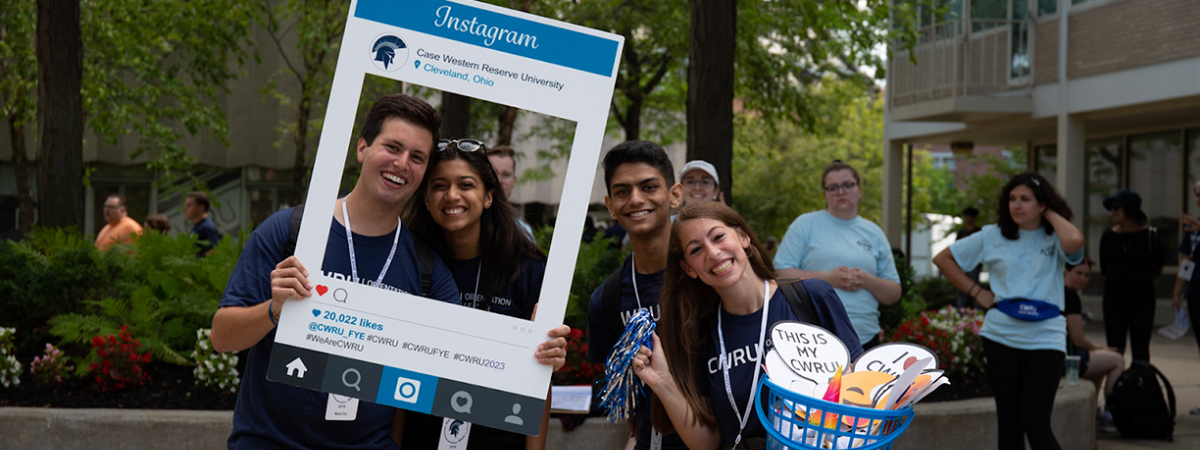 orientation leaders posing in a photo frame during move-in day