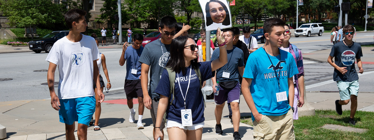 orientation leader walking with a group of students during Discover Week