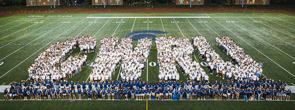 new students arranged in the shape of CWRU letters on DiSanto Field