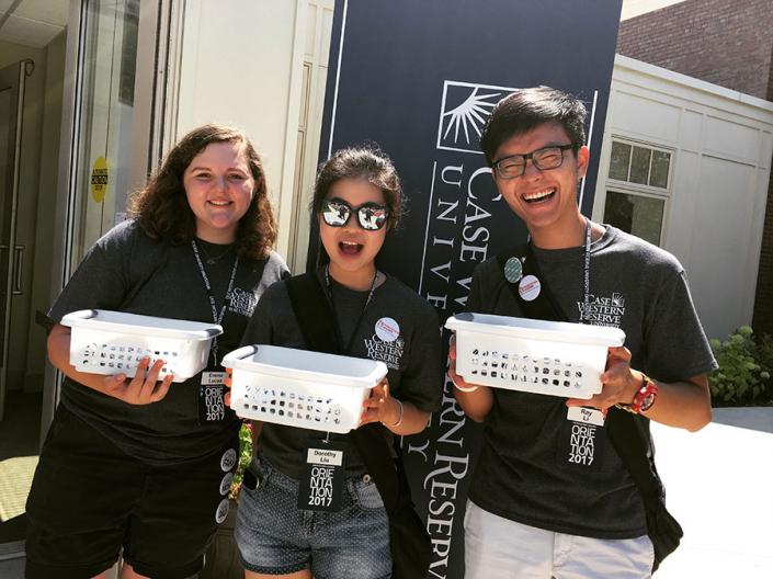Students holding baskets as they welcome first year students