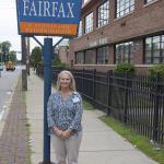 Amy Lower standing next to a Fairfax sign 