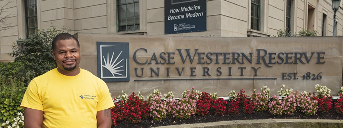 James Barnes standing next to a Case Western Reserve University sign 