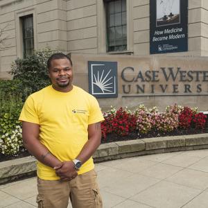 James Barnes standing next to a Case Western Reserve University sign 