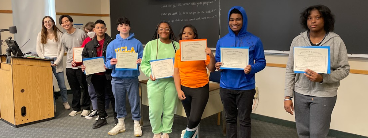Students in a line with certificates